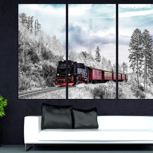 May include: A triptych canvas print featuring a vintage steam train traveling through a snowy landscape. The train is black and red, with red passenger cars. The surrounding forest is in black and white, with a touch of blue sky.