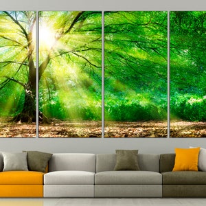 May include: A four-panel canvas print depicting a lush green forest scene with sunlight streaming through the trees. The print features a large tree in the centre, with its branches reaching out towards the sun.