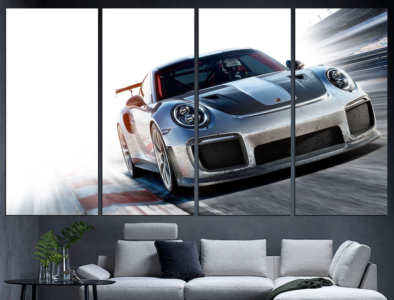 May include: A silver grey Porsche 911 GT2 RS sports car speeding on a race track. The car has a black stripe running down the center of the hood and a black rear wing.