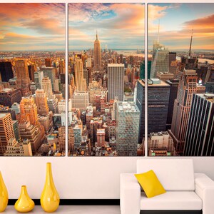 May include: A panoramic view of the New York City skyline at sunset, with the Empire State Building and other skyscrapers visible in the distance.