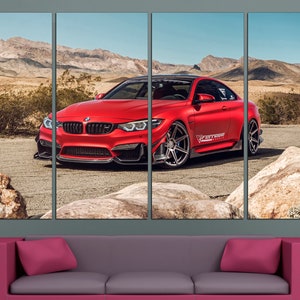 May include: A red BMW M4 sports car with black accents and a "Forged" logo on the side, parked on a desert road with mountains in the background.