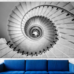 May include: A black and white photograph of a spiral staircase with a white railing. The staircase is made of marble and has a checkered pattern at the bottom.