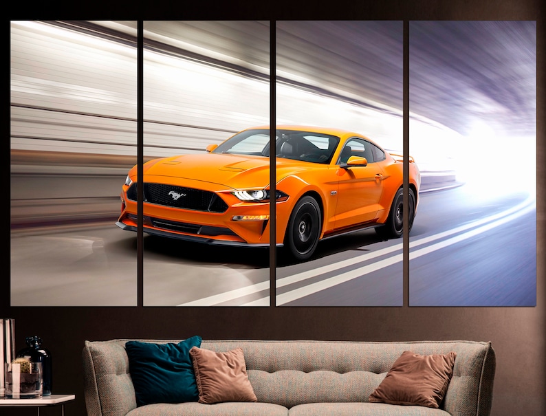 May include: A bright orange Ford Mustang sports car speeding through a tunnel with white lines on the road.