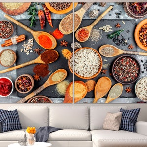 May include: A close-up image of various spices and grains in wooden spoons and bowls on a dark gray surface. The spices include black peppercorns, red pepper flakes, cumin, and cinnamon sticks. The grains include rice and quinoa.