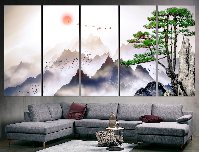 May include: A multi-panel canvas print depicting a misty mountain landscape with a lone pine tree in the foreground. The sky is a soft orange and pink, with a flock of birds flying overhead. The mountains are a muted blue and gray, with wispy clouds swirling around them.