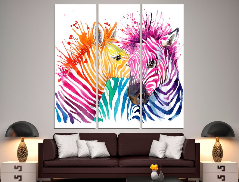 May include: Three colorful zebras with watercolor paint splatter in a modern art style. The zebras are painted in shades of pink, blue, green, yellow, and orange.