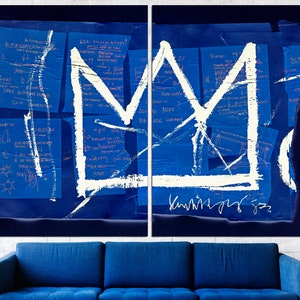 May include: A white crown painted on a blue background with handwritten notes and a signature. The crown is a simple design with a pointed top and a rounded base. The notes are in blue ink and are mostly illegible. The signature is in black ink and reads "Kaws 93".