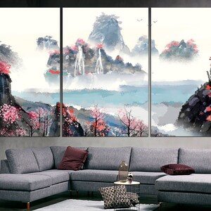 May include: A three-panel canvas print depicting a watercolor landscape with mountains, waterfalls, and pink blossoms. The scene is painted in shades of blue, gray, and pink, with a soft, ethereal feel.