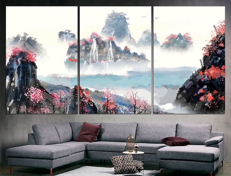 May include: A three-panel canvas print depicting a watercolor landscape with mountains, waterfalls, and pink blossoms. The scene is painted in shades of blue, gray, and pink, with a soft, ethereal feel.
