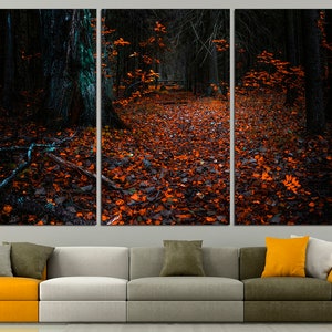 May include: A triptych canvas print of a dark forest path covered in fallen orange leaves. The path leads into the distance, with tall trees lining the sides.