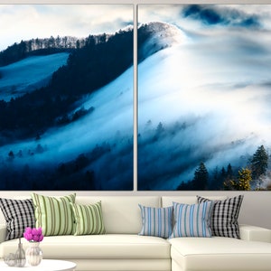 May include: A panoramic view of a misty forest with rolling hills and a blue sky. The fog is thick and white, creating a dreamy and ethereal atmosphere.