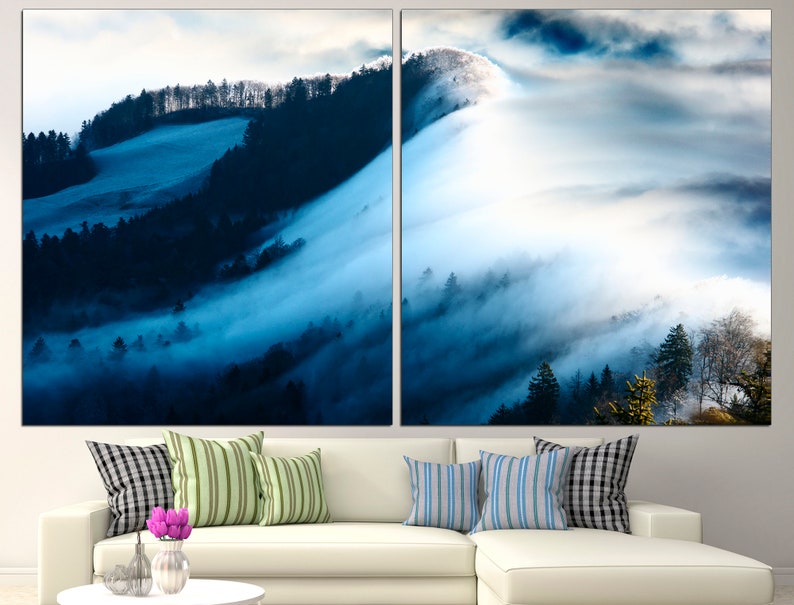 May include: A panoramic view of a misty forest with rolling hills and a blue sky. The fog is thick and white, creating a dreamy and ethereal atmosphere.