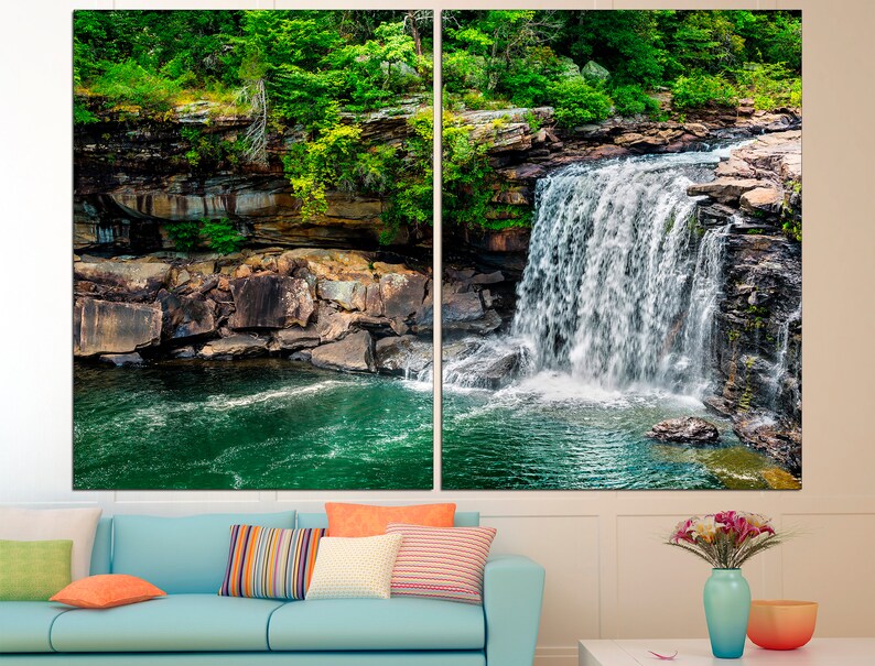 May include: A scenic photograph of a waterfall cascading over rocks into a pool of water. Lush green foliage surrounds the waterfall, creating a tranquil and natural setting.