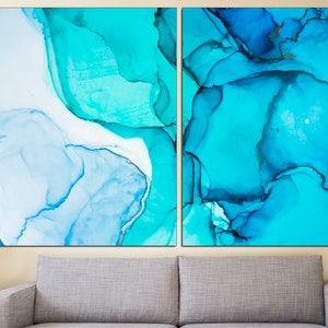 May include: Abstract art print featuring two panels with blue and turquoise watercolor-like designs. The panels are separated by a thin white space.