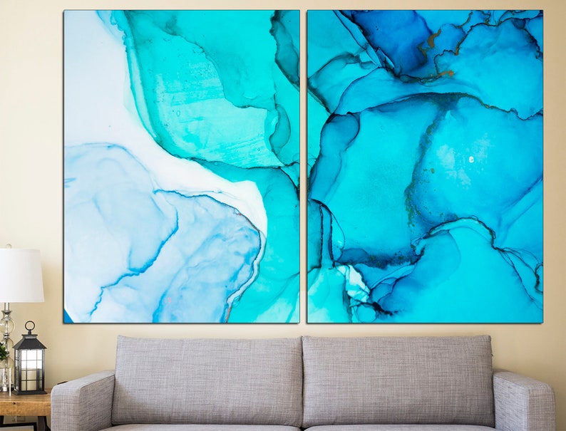 May include: Abstract art print featuring two panels with blue and turquoise watercolor-like designs. The panels are separated by a thin white space.