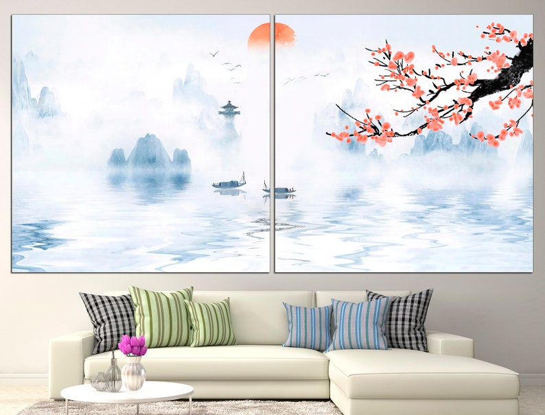 May include: A watercolor painting of a misty mountain landscape with a red sun in the sky. The mountains are reflected in the water, and there are pink blossoms on a tree branch in the foreground.
