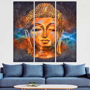 May include: A triptych canvas art piece featuring a serene Buddha head. The artwork showcases warm orange and gold tones, with a textured appearance. Blue and orange abstract elements surround the Buddha's head, creating a spiritual and artistic ambiance.