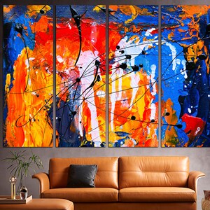 May include: Abstract art painting with a multi-panel design. The painting features bold strokes of blue, orange, yellow, and white paint. The painting is a modern and contemporary style.