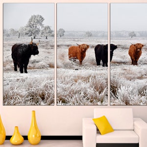 May include: A triptych canvas print featuring four Highland cattle standing in a snowy field. The cattle are brown and black with long horns. The field is covered in white snow and frost.