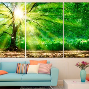 May include: A three-panel canvas print featuring a large tree with green leaves in a woodland setting. Sunlight streams through the branches, creating a bright and airy atmosphere.