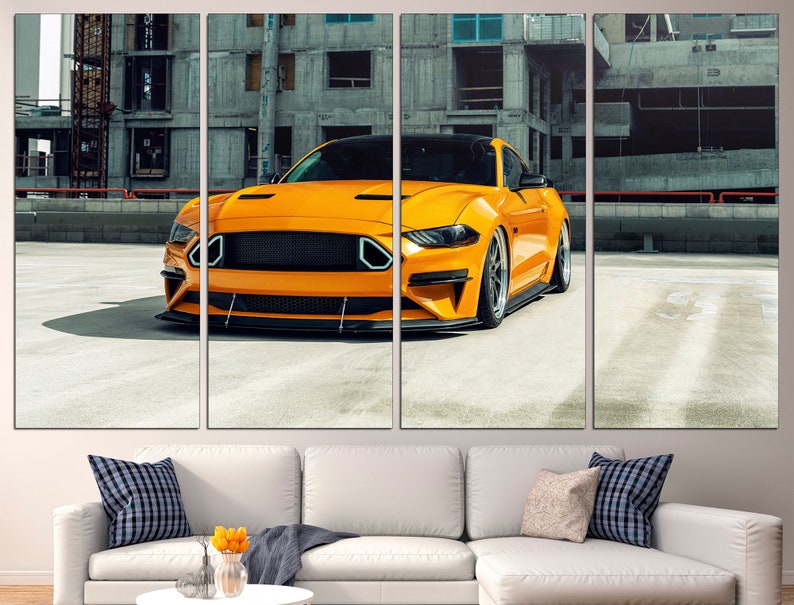 May include: A bright yellow sports car parked in a concrete car park. The car has a black grille and black wheels. The car is in focus, while the background is blurred.
