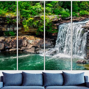 May include: A multi-panel canvas print featuring a waterfall cascading over moss-covered rocks and into a clear pool of water. The lush green foliage surrounding the waterfall adds a touch of natural beauty to the scene.