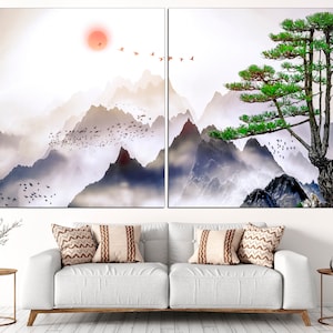 May include: A split canvas print featuring a misty mountain landscape with a single green pine tree on a rocky cliff. The sky is a soft white with a red sun in the distance.