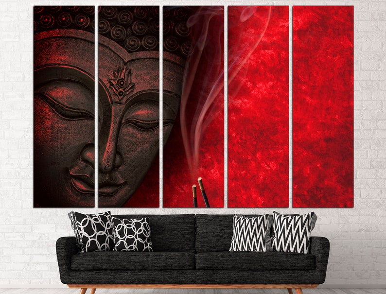 May include: A black and white Buddha statue with a red background and smoke rising from incense sticks. The statue is carved with intricate details and has a serene expression.