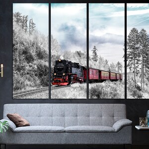May include: A multi-panel canvas print depicting a vintage steam train traveling through a snowy forest. The train is black and red, with red passenger cars. The forest is in black and white, with a blue sky.