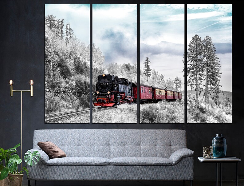 May include: A multi-panel canvas print depicting a vintage steam train traveling through a snowy forest. The train is black and red, with red passenger cars. The forest is in black and white, with a blue sky.
