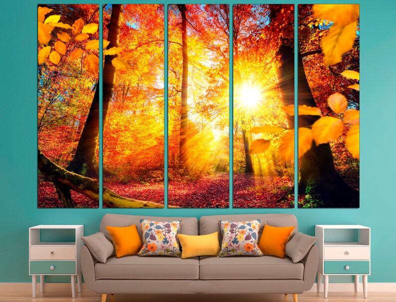 May include: A five-panel canvas print depicting a forest scene with vibrant autumn foliage in shades of orange, yellow, and red. Sunlight streams through the trees, creating a warm and inviting atmosphere.