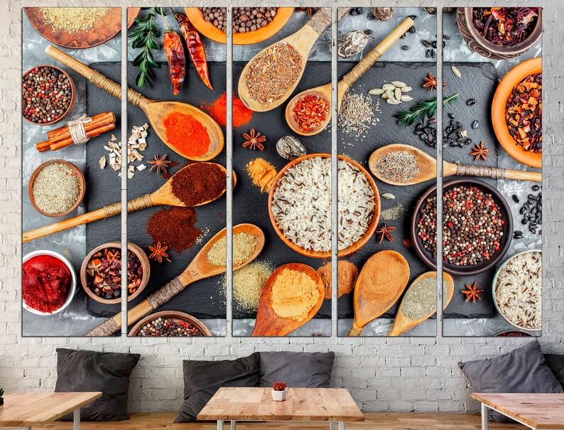 May include: A close-up of various spices and grains in wooden spoons and bowls on a black slate background. The spices include black peppercorns, cumin seeds, coriander seeds, and red pepper flakes. The grains include rice, quinoa, and couscous.