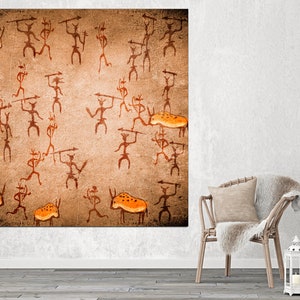 May include: A brown canvas print with an orange and brown cave painting of stick figures hunting animals. The figures are holding spears and the animals are bison.