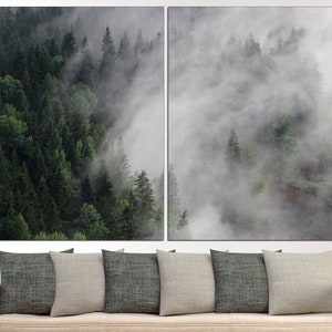 May include: A split-panel canvas print featuring a misty forest scene. The left panel shows a dense forest with lush green trees, while the right panel depicts a foggy, ethereal landscape with wispy clouds.