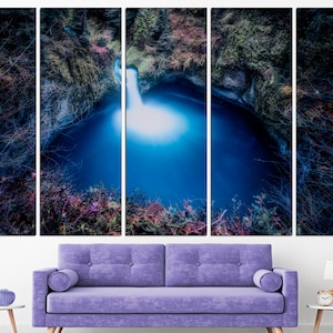 May include: A panoramic view of a waterfall cascading into a deep blue pool surrounded by lush greenery. The water is illuminated by the sunlight, creating a bright, ethereal glow.