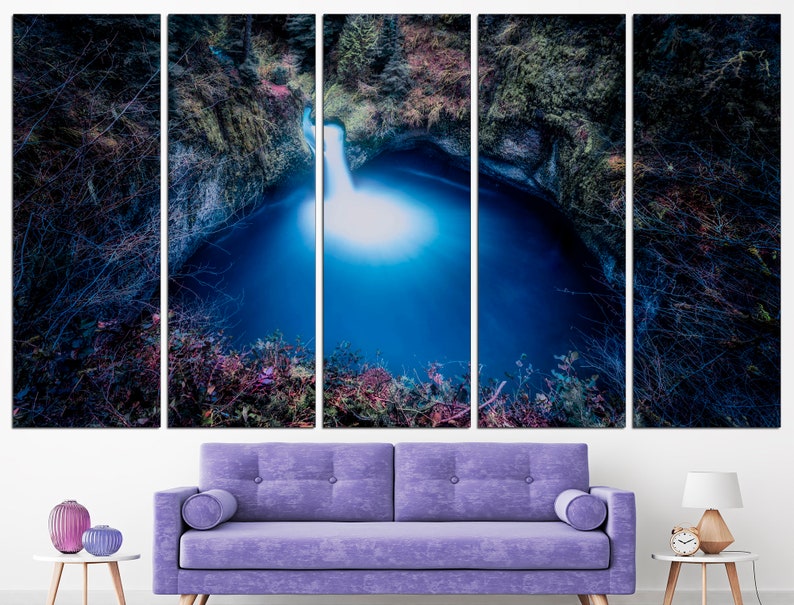 May include: A panoramic view of a waterfall cascading into a deep blue pool surrounded by lush greenery. The water is illuminated by the sunlight, creating a bright, ethereal glow.