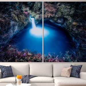 May include: A split canvas print of a waterfall cascading into a deep blue pool surrounded by lush greenery. The image is taken from a low angle, giving the viewer a sense of being immersed in the scene.