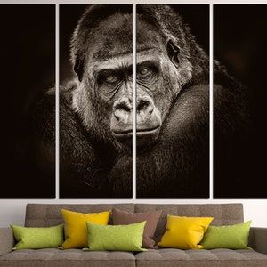 May include: A black and white close-up photograph of a gorilla's face. The gorilla is looking directly at the camera with a serious expression. The image is split into five panels.