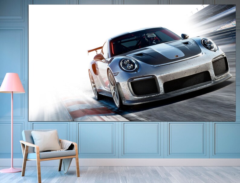 May include: A silver Porsche 911 GT3 RS race car speeding on a track with a blurred background.