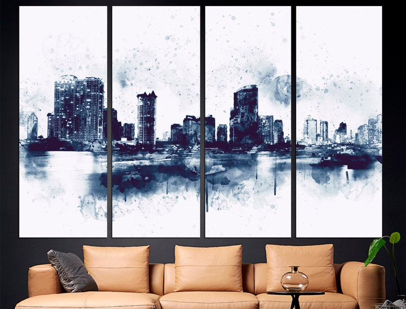 May include: A watercolor painting of a city skyline in shades of blue and white. The painting is divided into three panels, each depicting a different section of the city. The buildings are tall and slender, and the water in the foreground is calm and reflective.