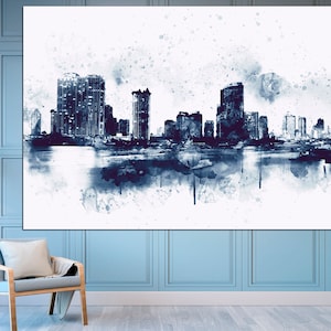 May include: A watercolor painting of a city skyline in shades of blue and white. The buildings are silhouetted against a white background with splatters of blue paint.
