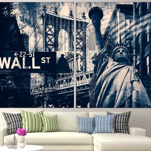 May include: A two-panel canvas print featuring a collage of New York City landmarks in shades of blue and white. The image includes the Statue of Liberty, the Manhattan Bridge, and a Wall Street sign.