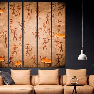 May include: A five-piece canvas wall art set featuring a brown background with orange and black figures and animals. The figures are stylized and resemble cave paintings.