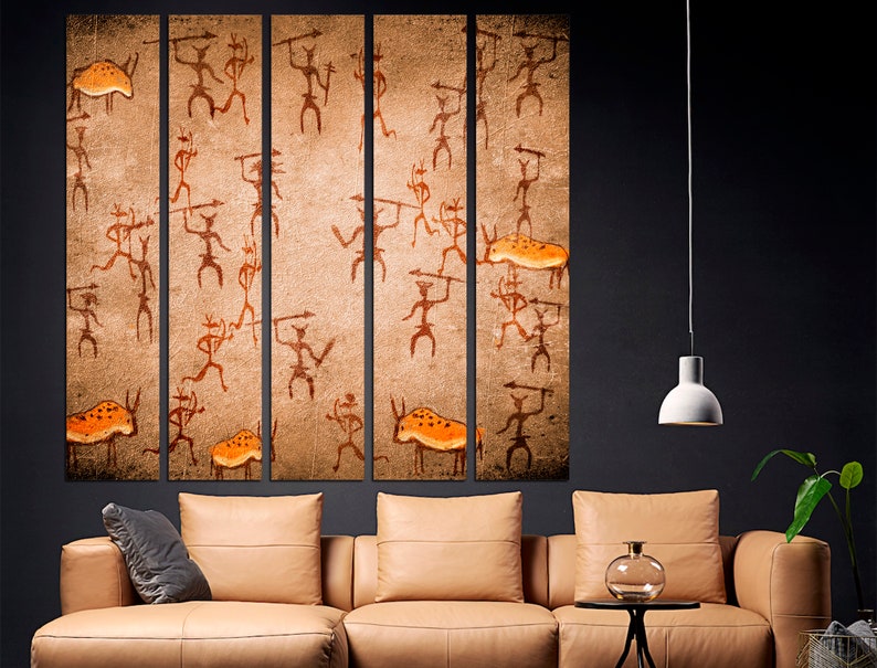 May include: A five-piece canvas wall art set featuring a brown background with orange and black figures and animals. The figures are stylized and resemble cave paintings.