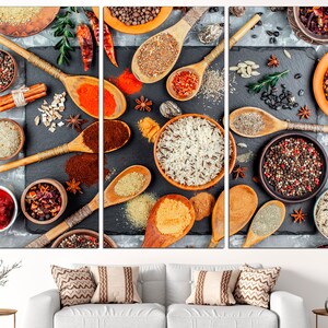 May include: A close-up of a variety of spices and herbs arranged on a black surface. The spices are in small bowls and spoons, and include cumin, coriander, turmeric, peppercorns, and chili flakes. The herbs are in small bunches and include rosemary, thyme, and oregano.
