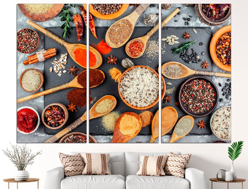 May include: A close-up of a variety of spices and herbs arranged on a black surface. The spices are in small bowls and spoons, and include cumin, coriander, turmeric, peppercorns, and chili flakes. The herbs are in small bunches and include rosemary, thyme, and oregano.