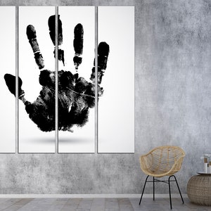 May include: A black and white canvas print of a handprint on a white background. The print is divided into four sections. The handprint is centered on the canvas.