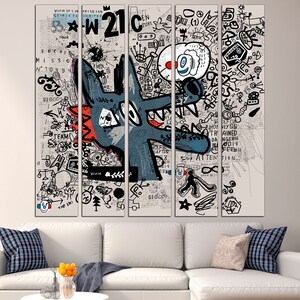May include: A multi-panel canvas print featuring a cartoon wolf with a red nose and a blue and white background. The background is covered in scribbles and text, including the words "W21" and "ATTENTION".