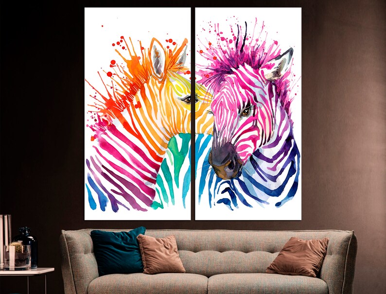 May include: Two colorful zebra heads painted in a watercolor style with splashes of color. The zebra on the left is painted in shades of orange, yellow, pink, and purple. The zebra on the right is painted in shades of blue, purple, and pink.