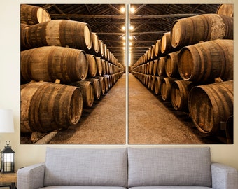 May include: A split-level photo of a wine cellar with rows of wooden barrels stacked high. The barrels are arranged in a symmetrical pattern, creating a sense of depth and perspective. The barrels are made of dark wood and have metal bands around them.